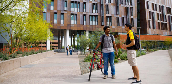students on campus biking
